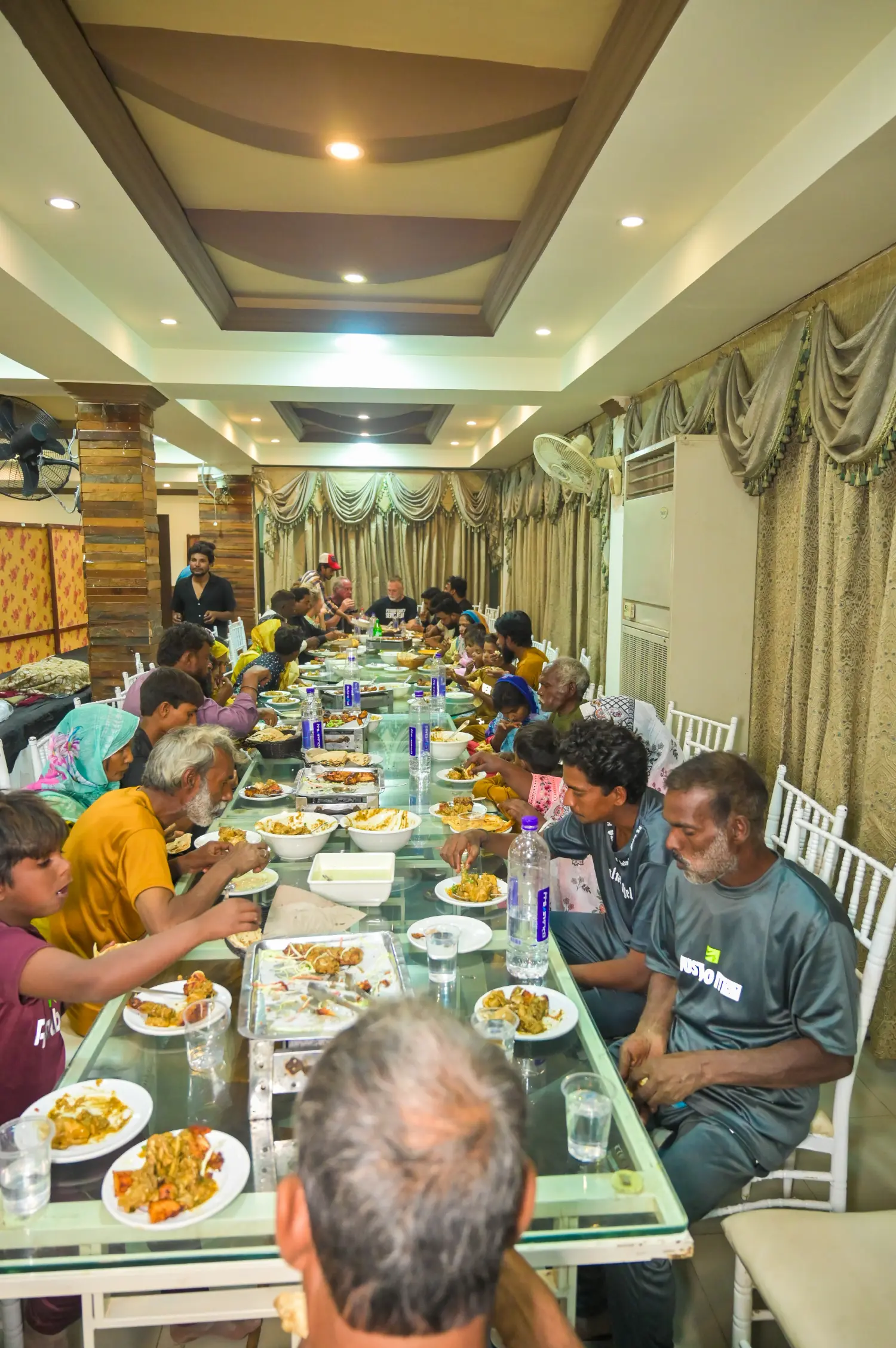 A massive dinner table and feast with rescued families