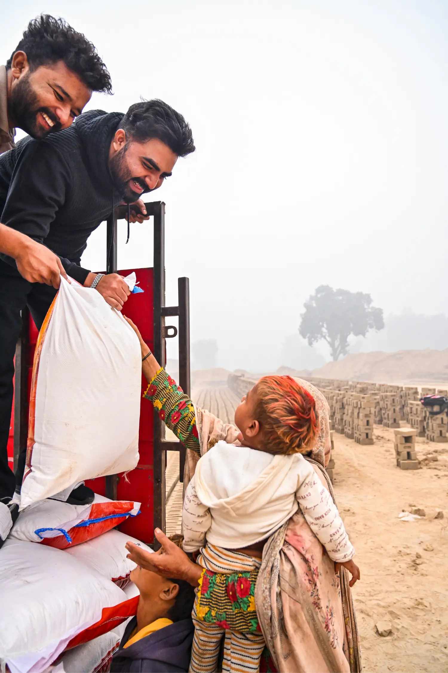 A mother and her children receiving food rations with joy