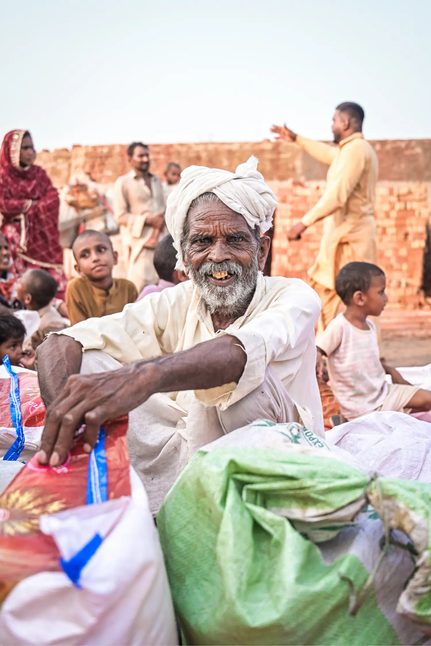 An Elder Sits With His Ration