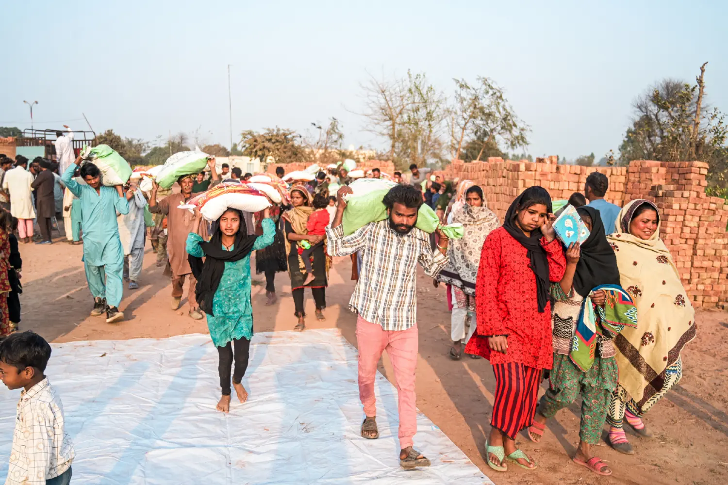 Families walking home carrying their food rations