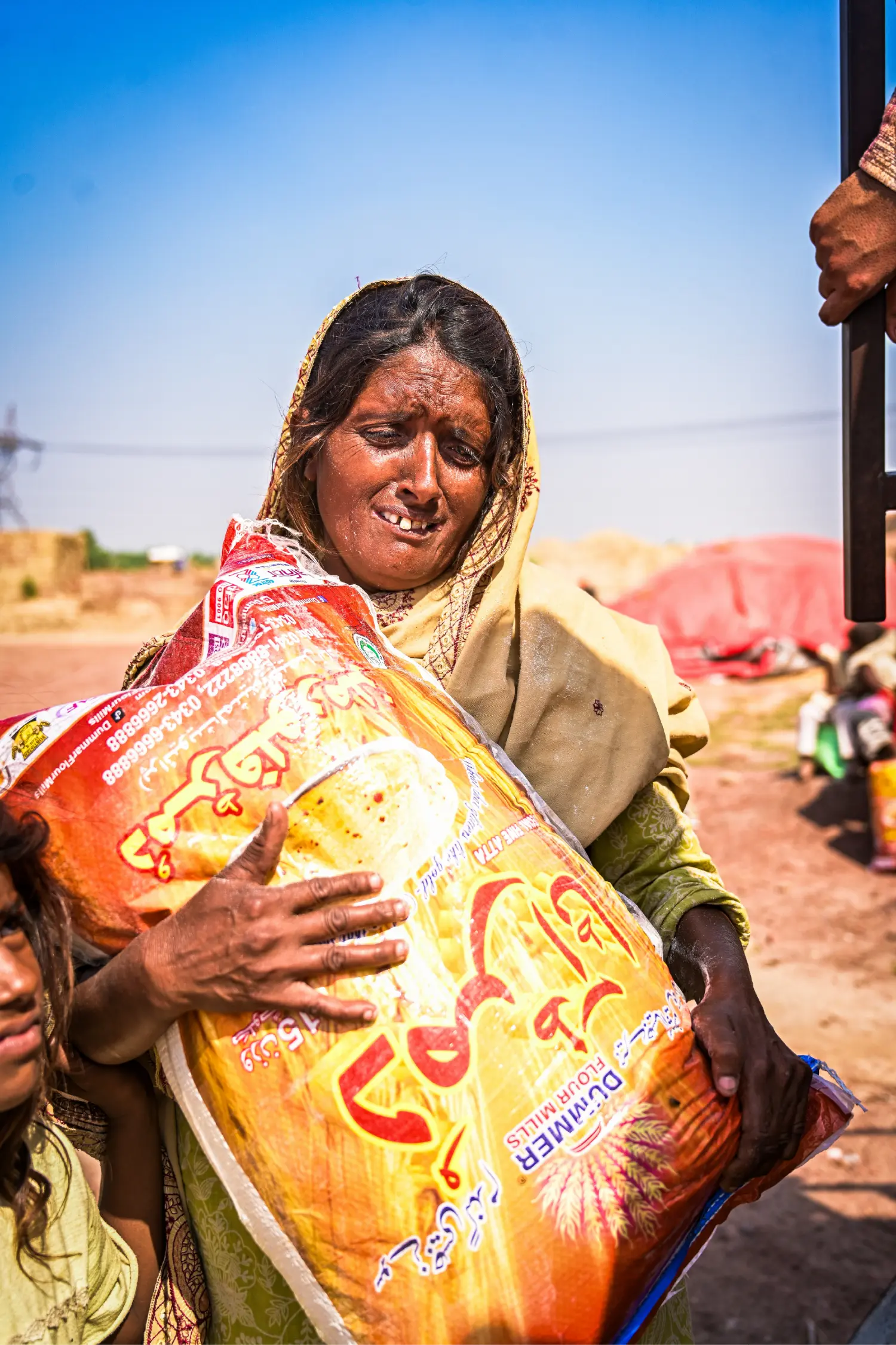 A woman receiving a food ration package from H.O.P.E.
