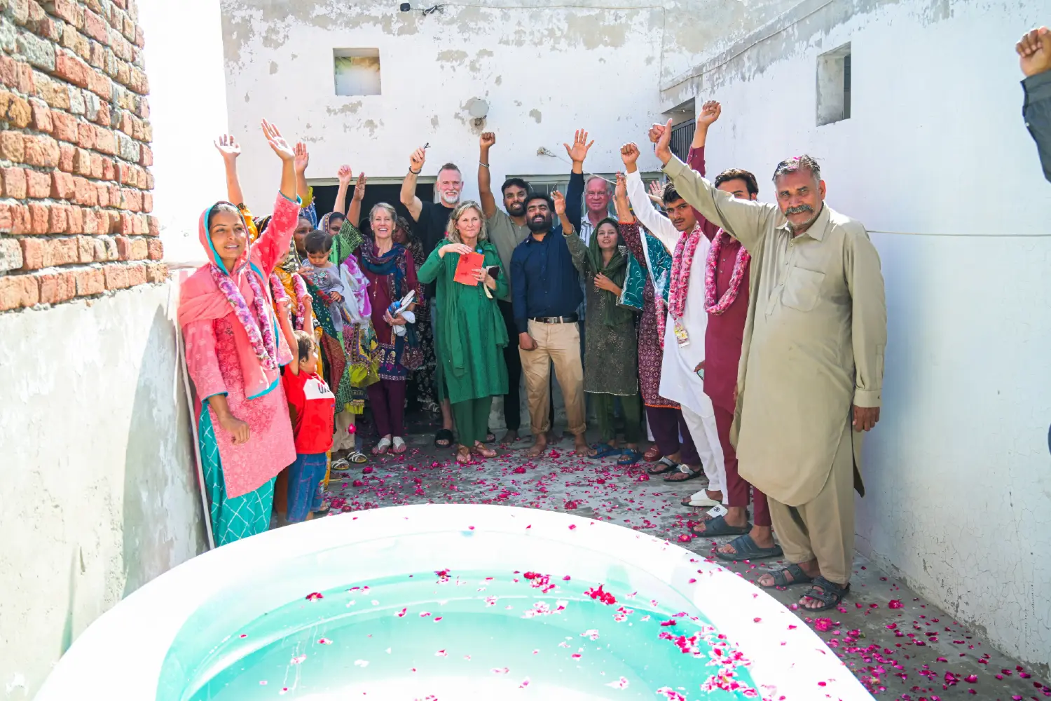 Group photo of newly baptized believers with the H.O.P.E. team