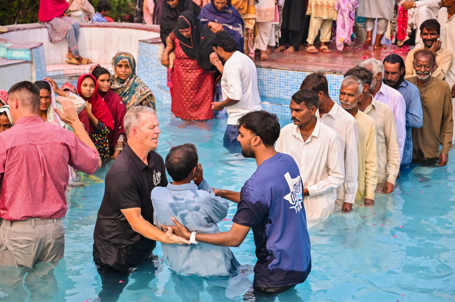 Pastor Suryani Javed and Pastor Danny baptizing believers