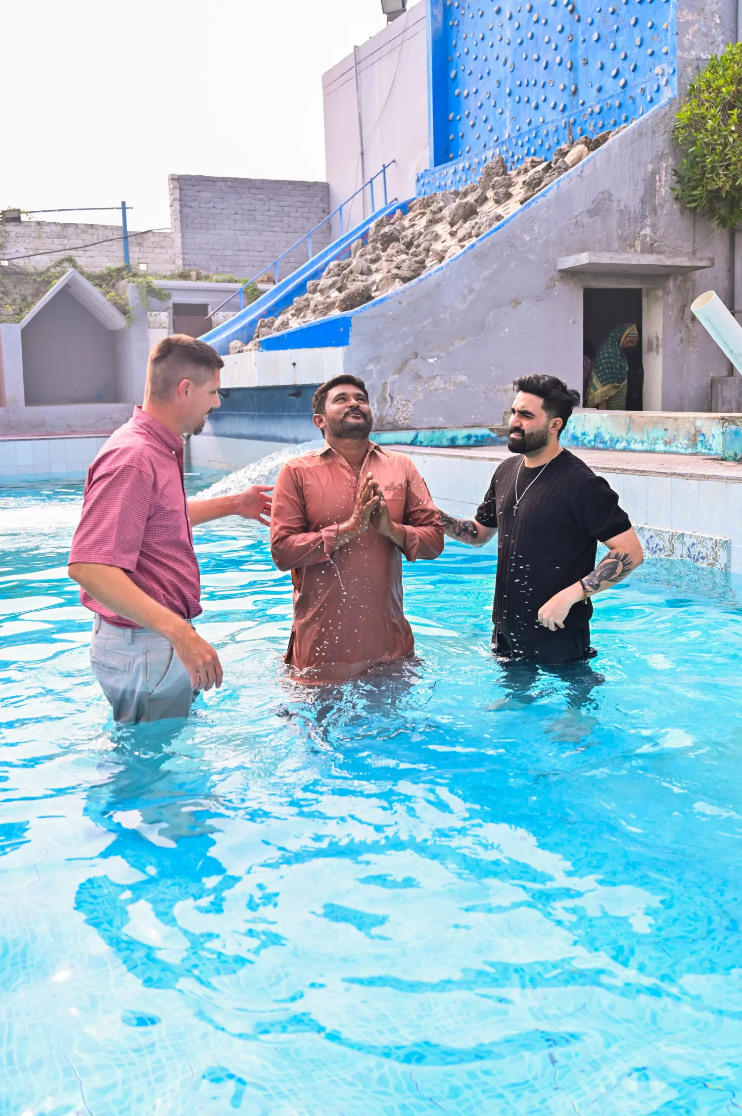 Pastor Ashkar Javed and Pastor Cody baptizing a man