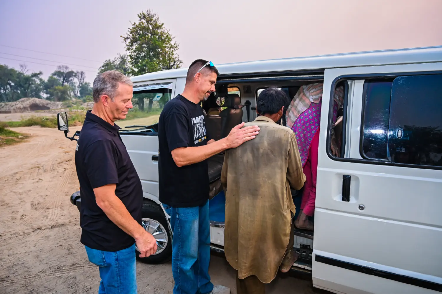 H.O.P.E. team loading freed families into vans