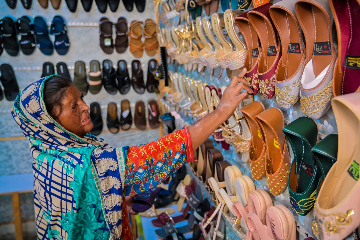 A woman purchasing shoes after being freed