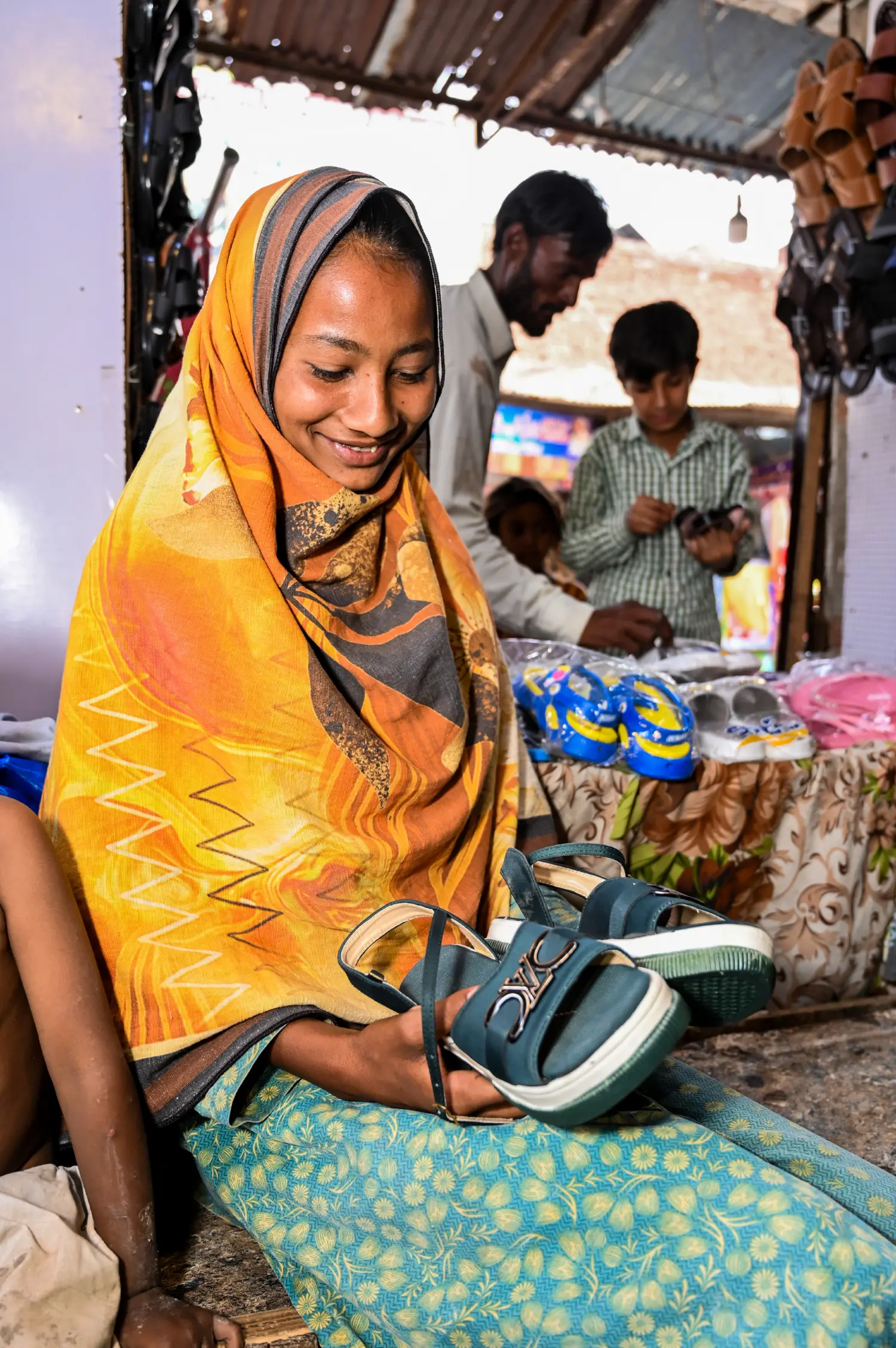 A girl buying shoes and laughing