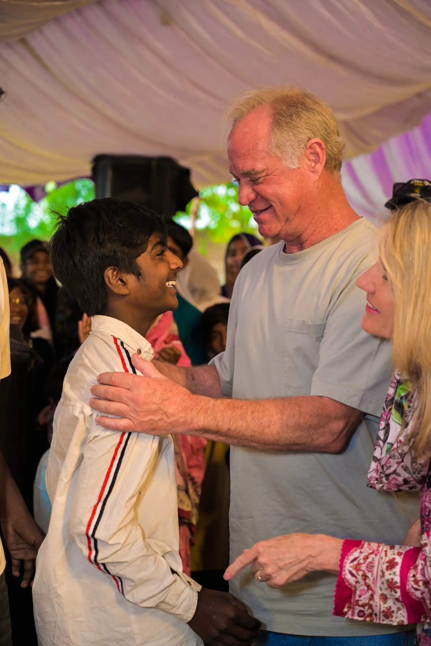 Mr. King hugging a boy at the celebration