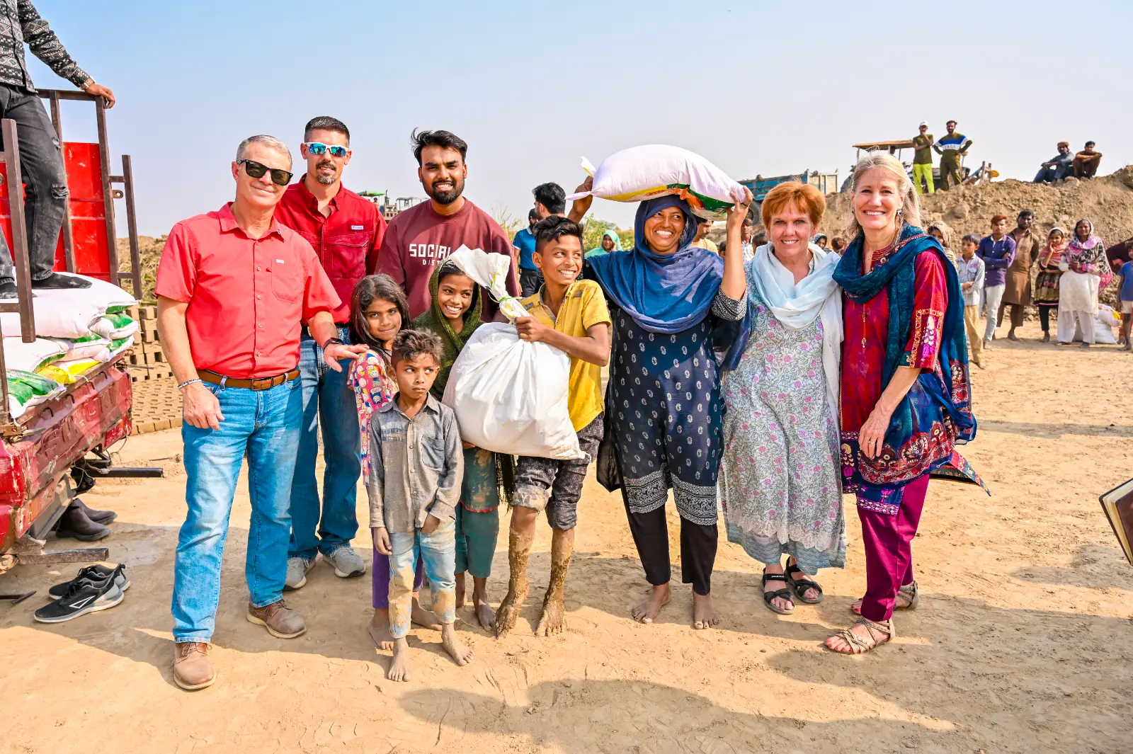 Pastor Suryani Javed, President Ruth King and the H.O.P.E. team with a family who just received food rations