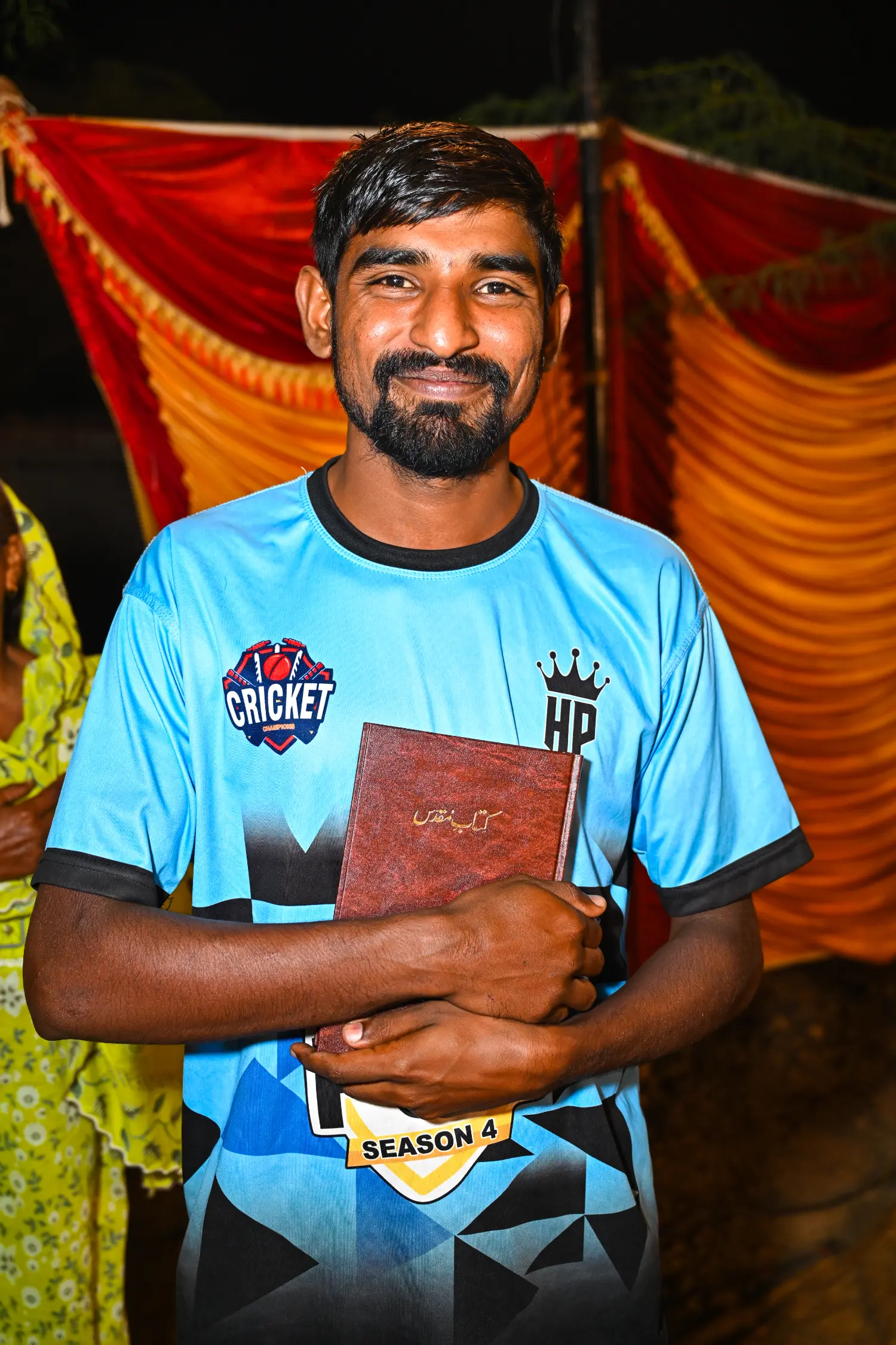 A man holding the Holy Bible to his chest, smiling with joy