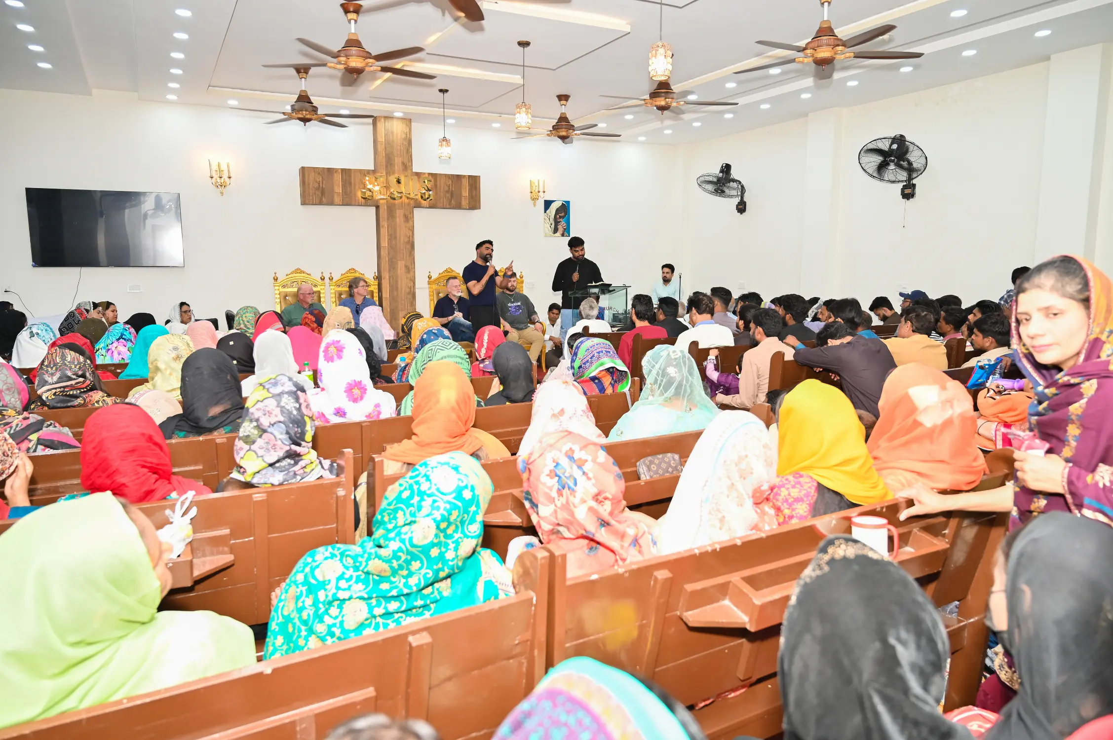 Pastor Suryani Javed and Pastor Ashkar Javed preaching at New Hope Church with partner guests from the United States