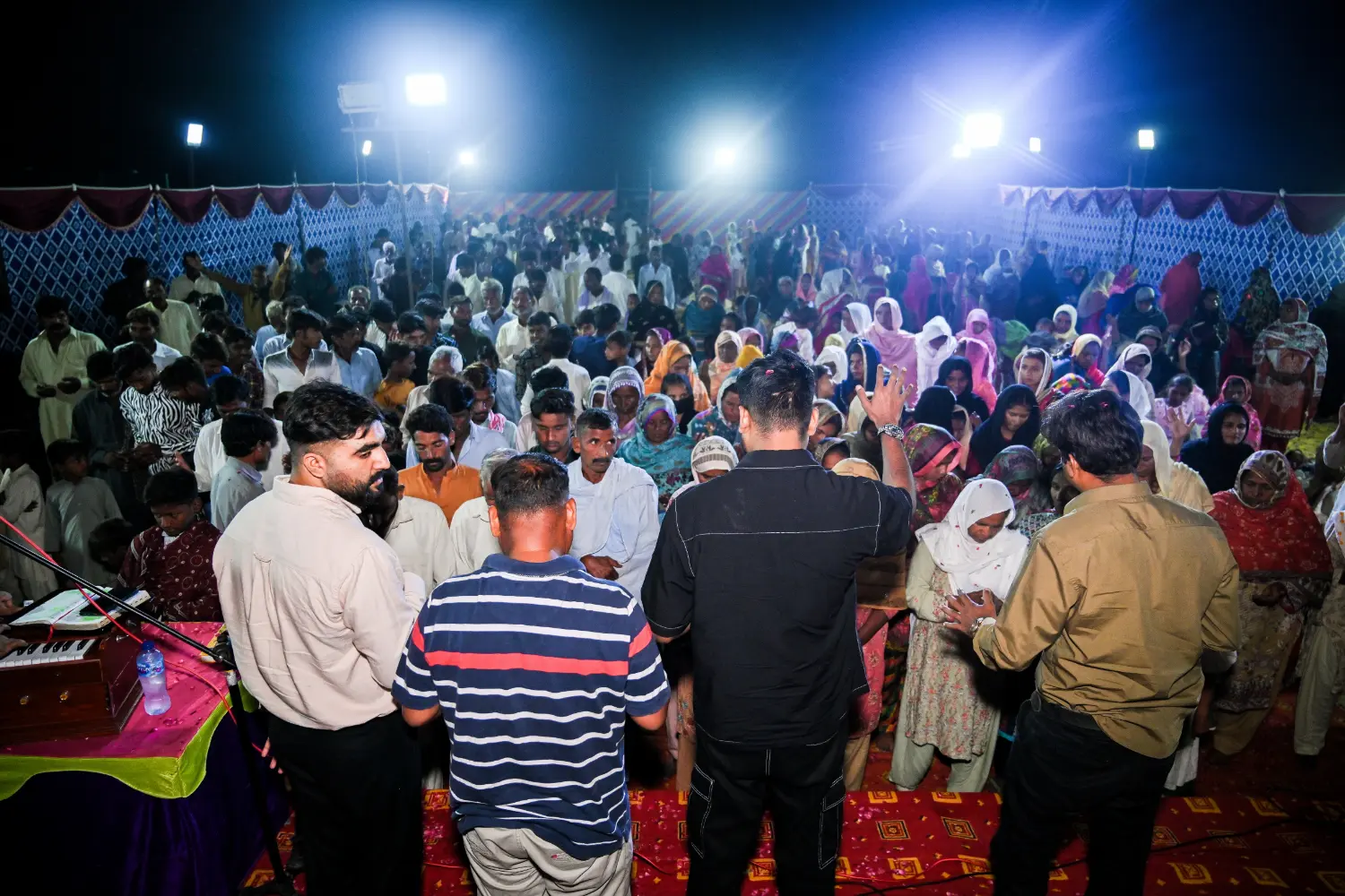H.O.P.E. Pakistan team praying at a crusade