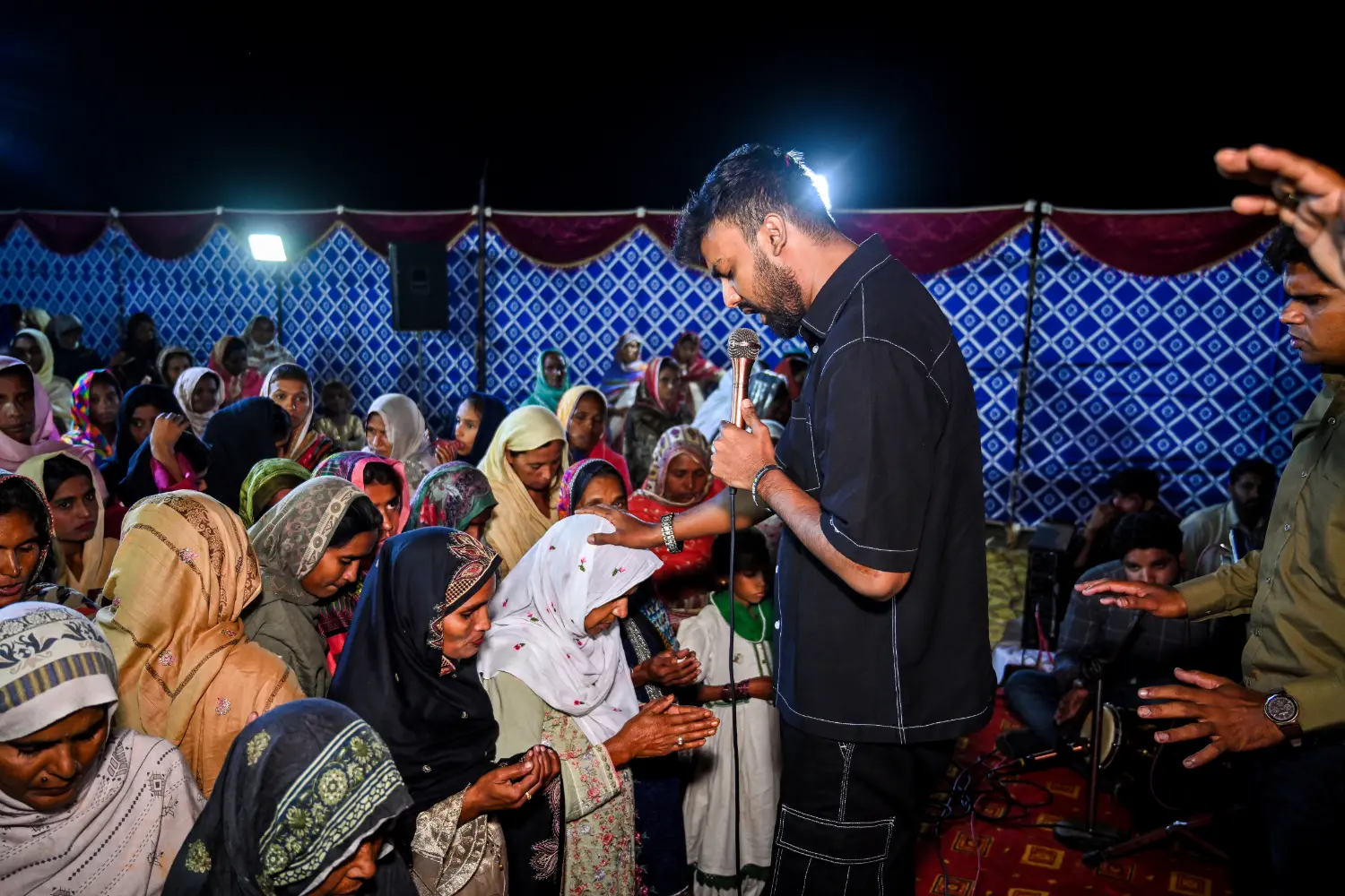 Pastor Suryani Javed praying over people