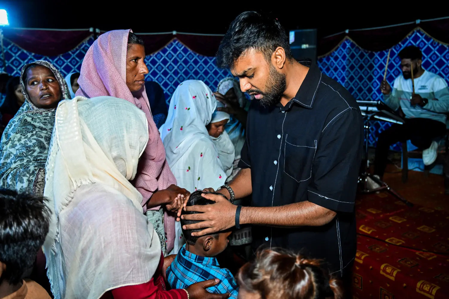 Pastor Suryani Javed preaching to children at a crusade