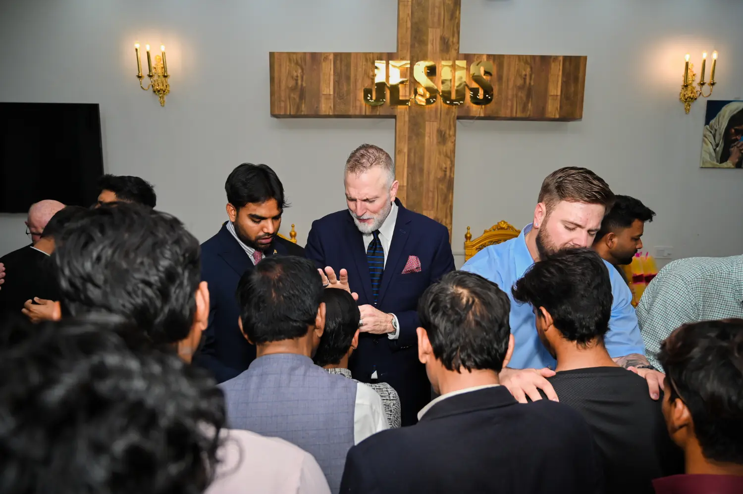 Pastor Suryani Javed and pastors from the United States praying over a pastor