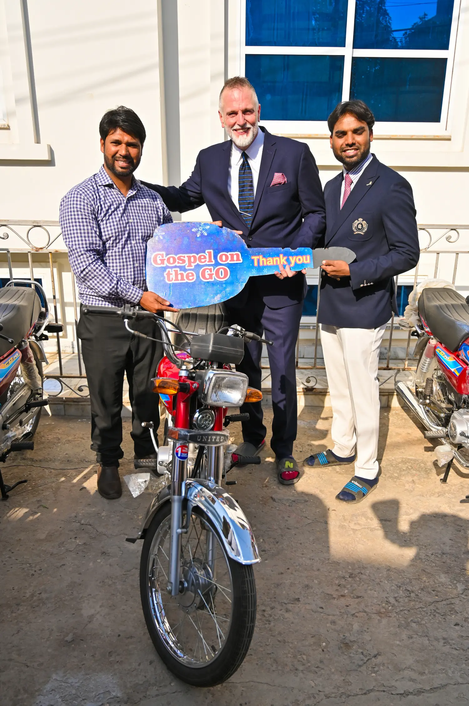 Pastor Mark and Pastor Suryani Javed gifting a motorbike to a pastor for evangelism