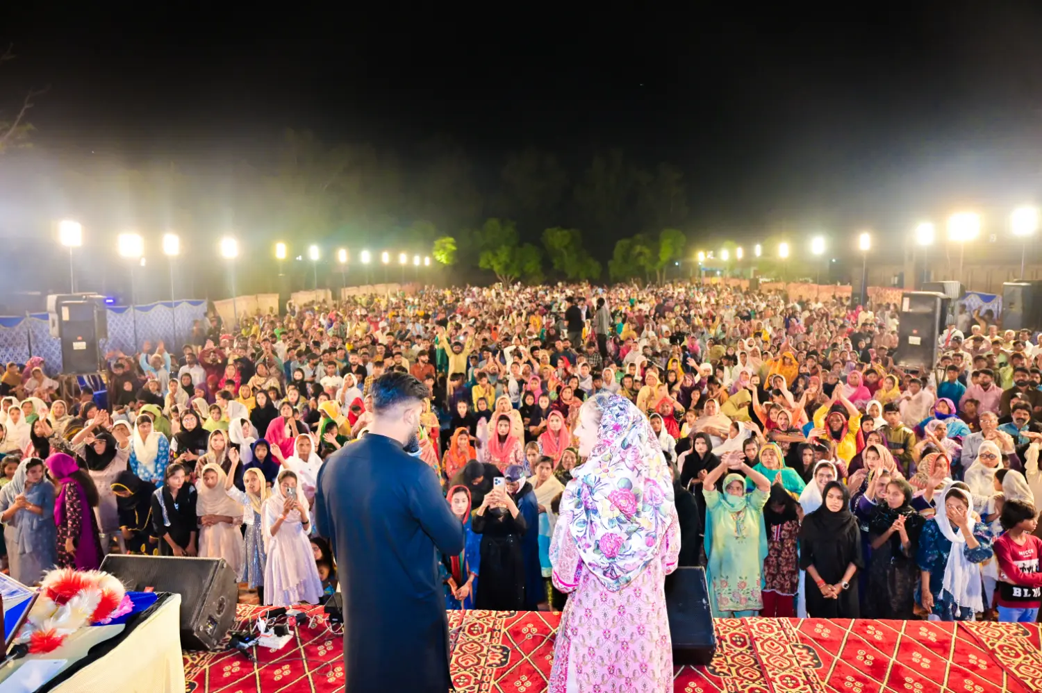 Pastor Ashkar Javed and President Ruth King preaching at a crusade