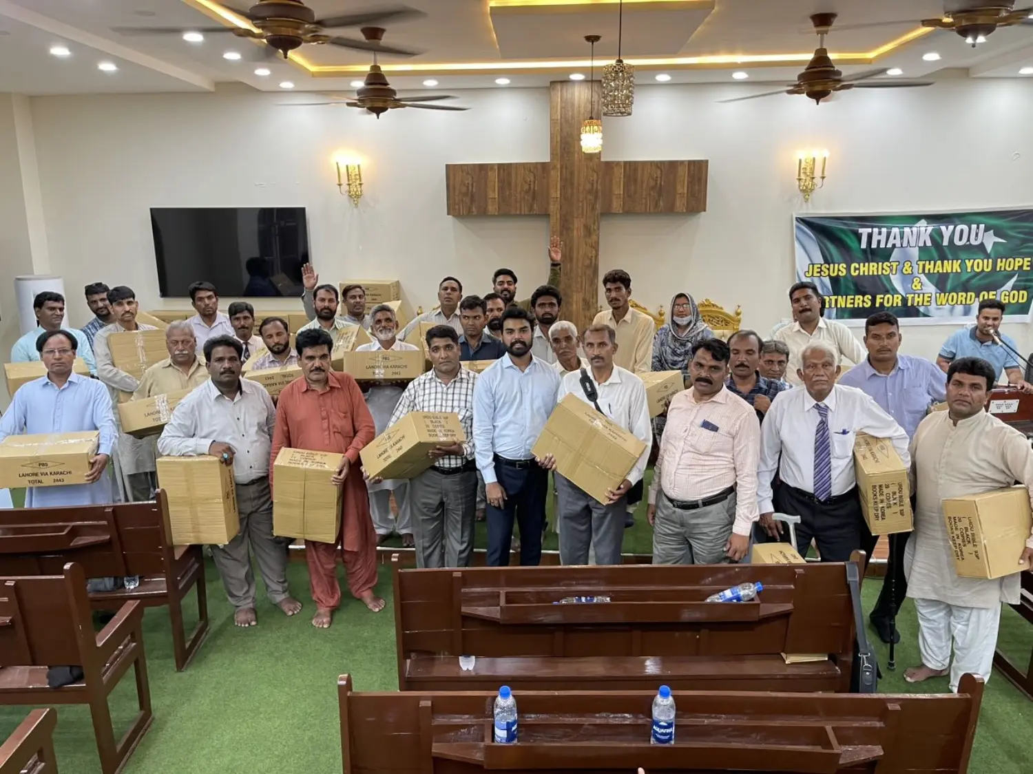 Pastor Suryani Javed giving Holy Bible packs to a team of pastors to distribute