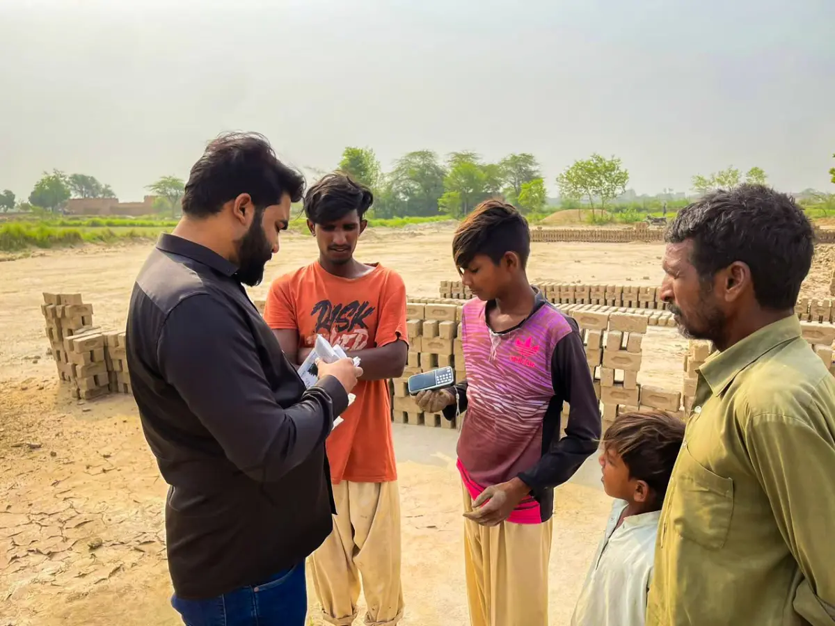 Pastor Ashkar distributing audio Bibles to people who cannot read